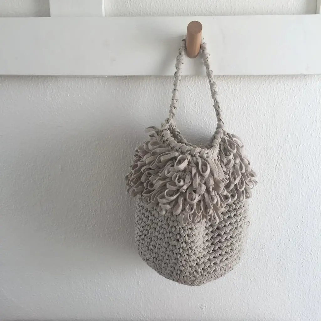 light beige crochet hanging basket on entryway holder for home organization