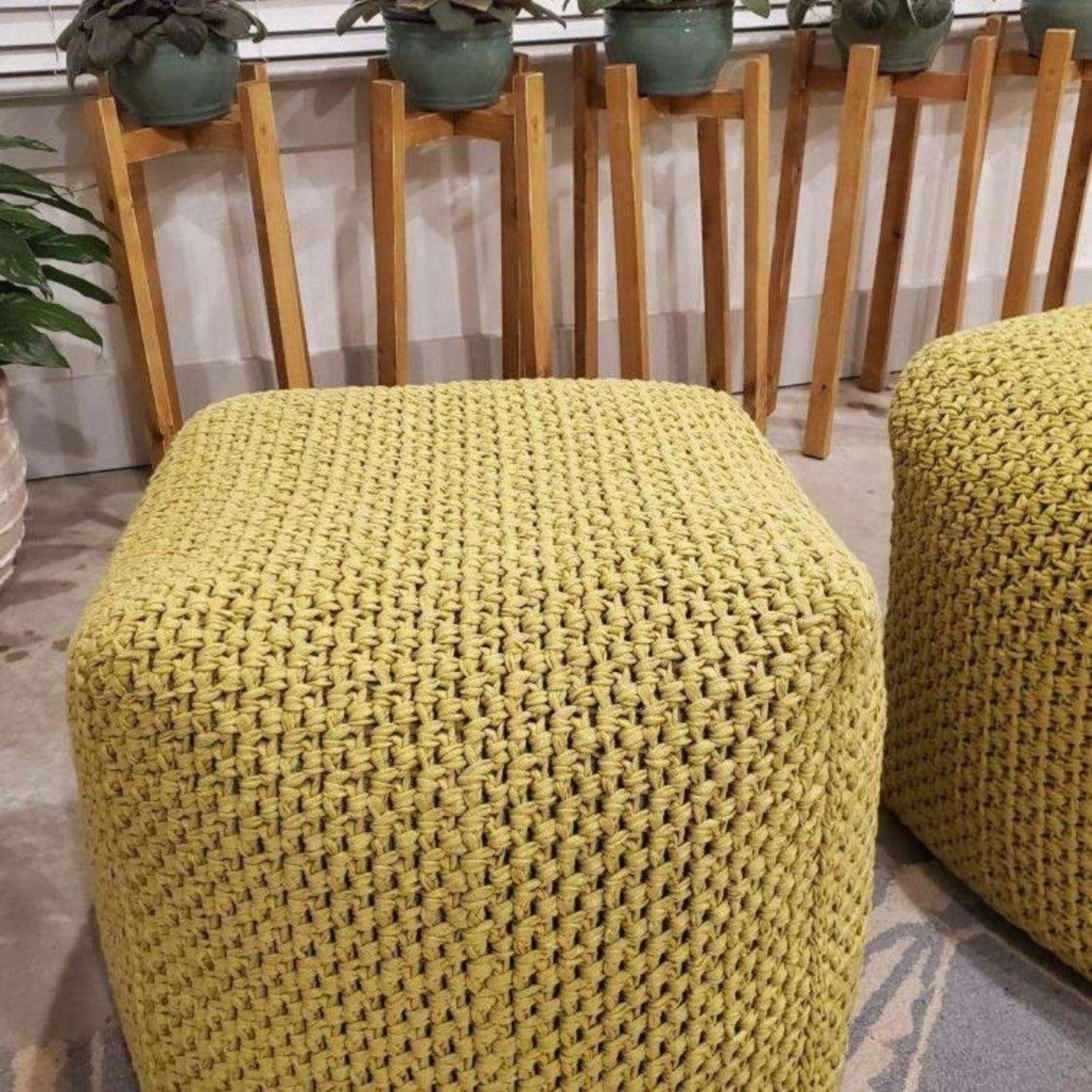 Pair of square ottoman covers in a vibrant yellow on a cozy rug