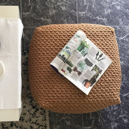 Lifestyle image of a square ottoman cover with a magazine for scale